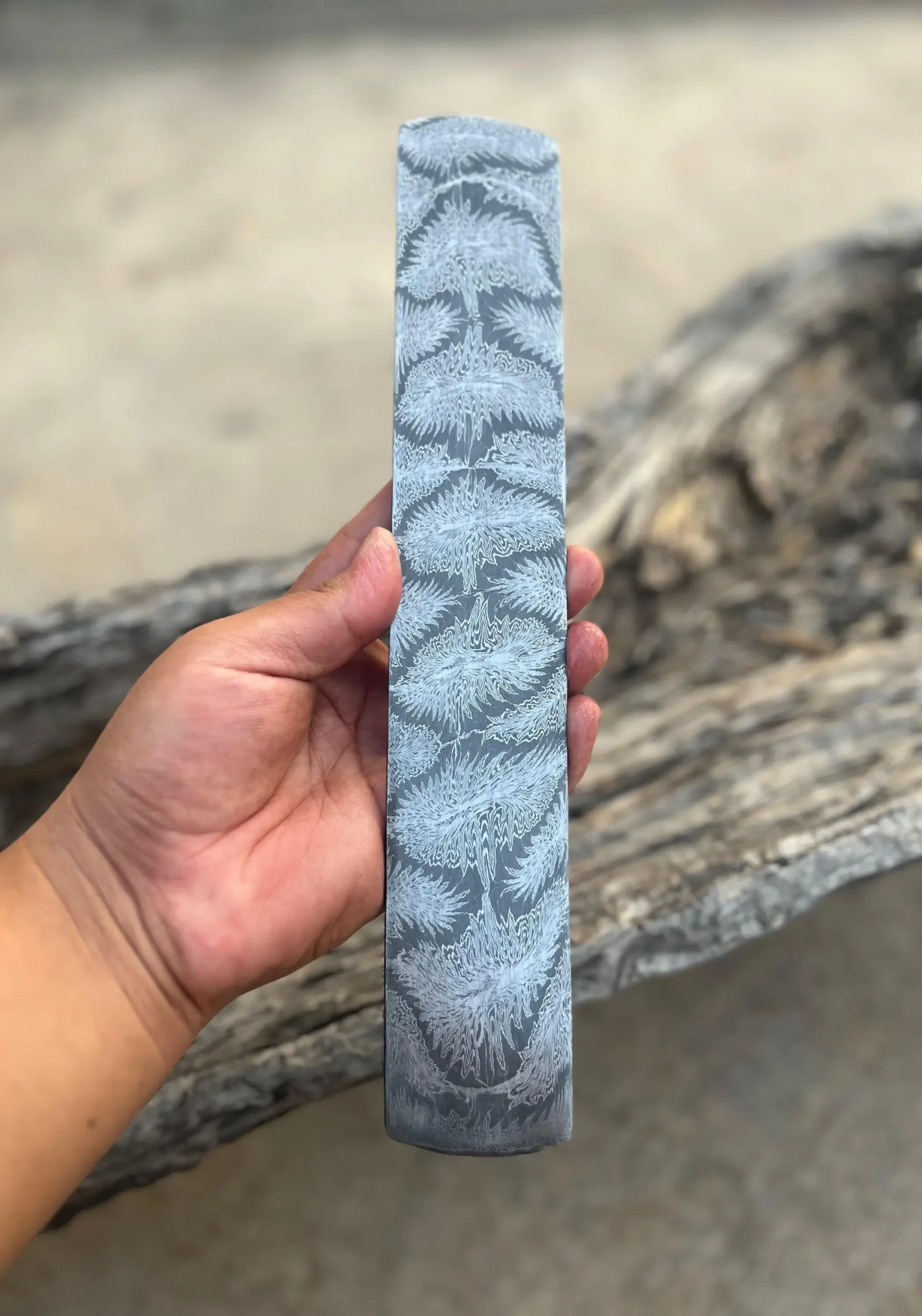 Hand holding fire blossom mosaic Damascus steel billet with etched Fire Blossom pattern – 280mm x 50mm x 3.4mm – custom knife making billet