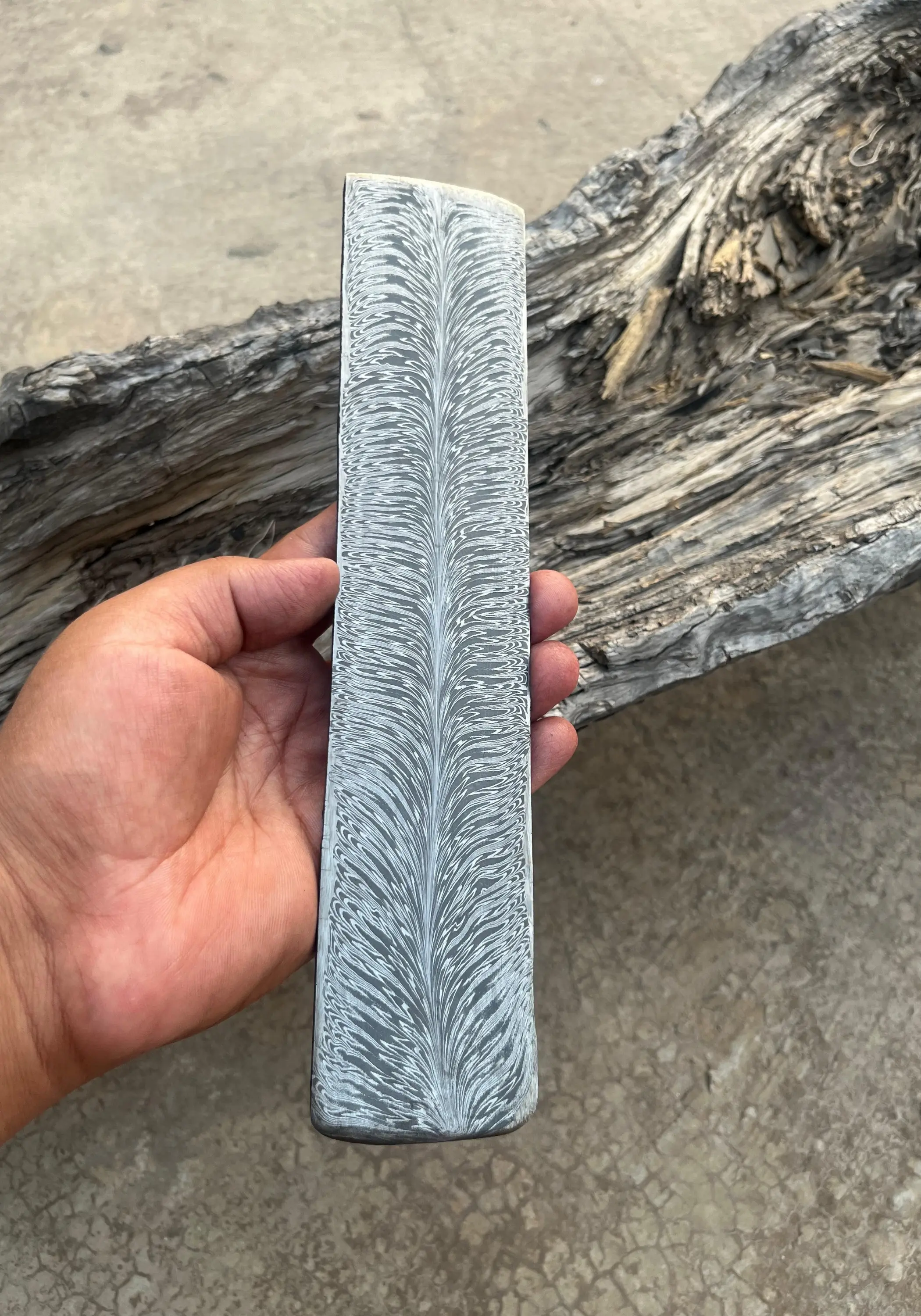 amascus steel billet with Fire Feather pattern held in hand – 280mm x 50mm x 3.4mm – artisan-forged for custom blades