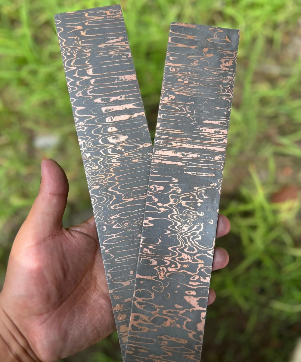 San Mai copper ladder pattern Damascus steel bar close-up for professional knife and sword bladesmithing